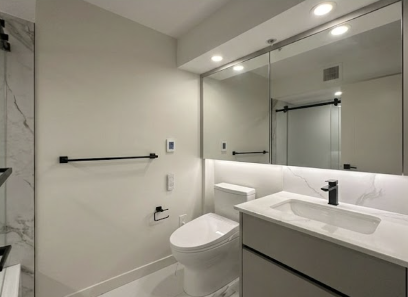 Bathroom vanity with LED mirror and marble tile